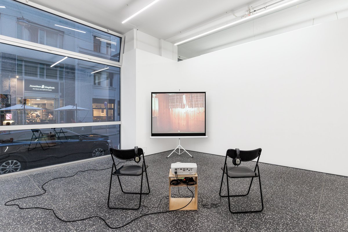 Julie BeckerFederal Building with Music, 2002DVD, projector screen and wood bench29:08 minCourtesy of Greene Naftali, New York