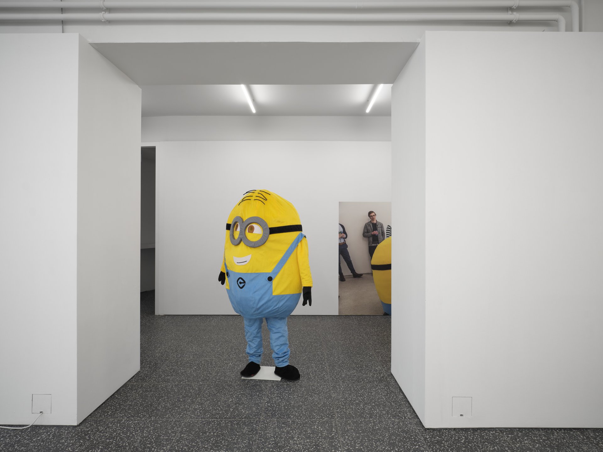 Installation view, Support, Curated By, Gaylen Gerber, Layr, Vienna, 2024Left to right: Puppies Puppies (Jade Guanaro Kuriki-Olivo), Dave Despicable Me, Minion Costume (commercially available), 2015, approximately 182.8 x 91.4 cm (72 x 36 inches); Puppies Puppies (Jade Guanaro Kuriki-Olivo), performance: Despicable Me, 2015, What Pipeline, Detroit, MI, Courtesy the artist and What Pipeline, Detroit, Photo: Alivia Zivich