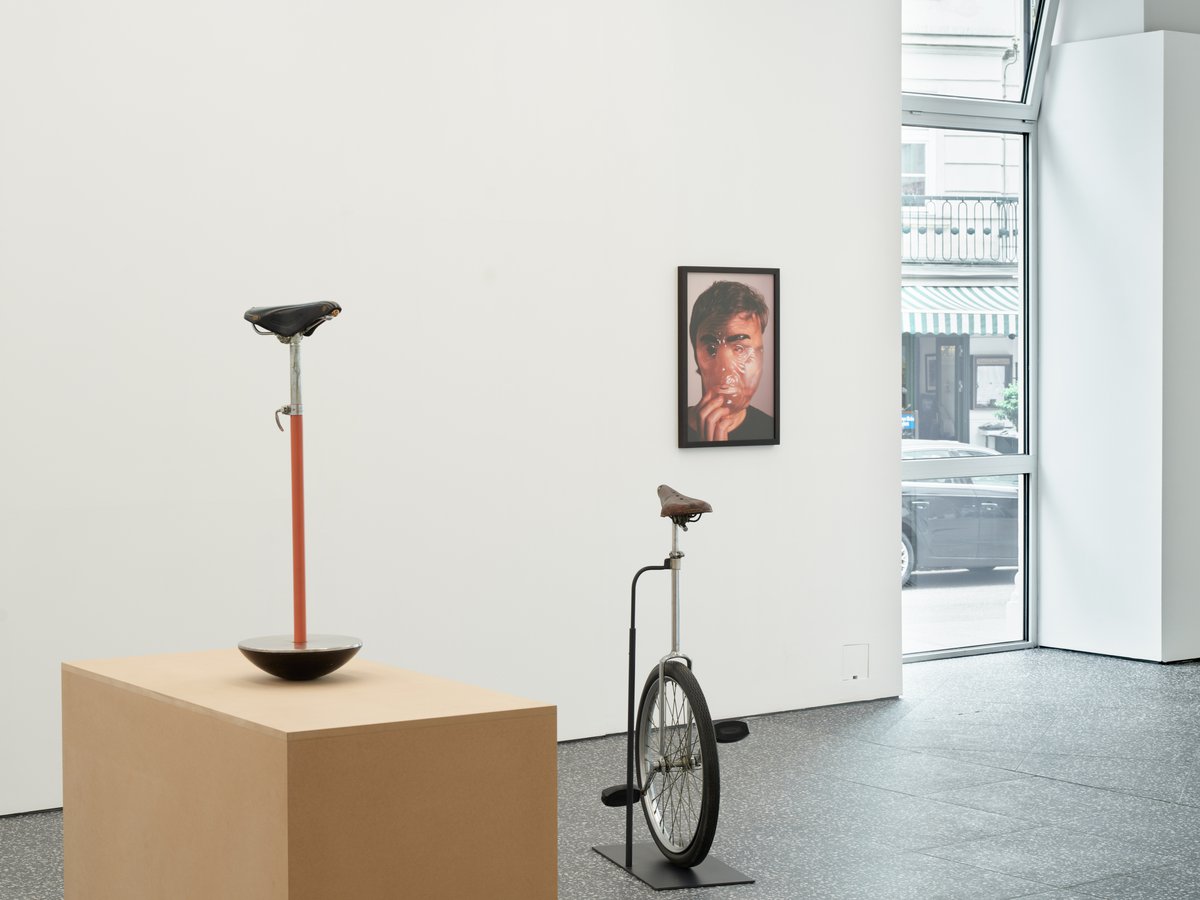 Installation view, From left: Gaylen Gerber, Support, n.d., Sella stool, Achille and Pier Giacomo Castiglioni, manufactured by Zanotta, Italy, 1957, enameled steel, stainless steel, leather, chrome plated steel, 76 x 28 x 30 cm (30 x 11 x 12 inches); Gaylen Gerber, Support, n.d. unicycle from entertainer Ray Royce’s nightclub and television act, Persons Majestic Manufacturing Company, United States, mid-20th century, on base, 112.3 x 61 x 43 cm (44¼ x 24 x 17 inches); Jeanne Dunning, Untitled, 2004, Epson Ultrachrome inks on Hahnemühle paper and frame, United States, 72.3 x 51.4 cm (28½ x 20¼ inches)