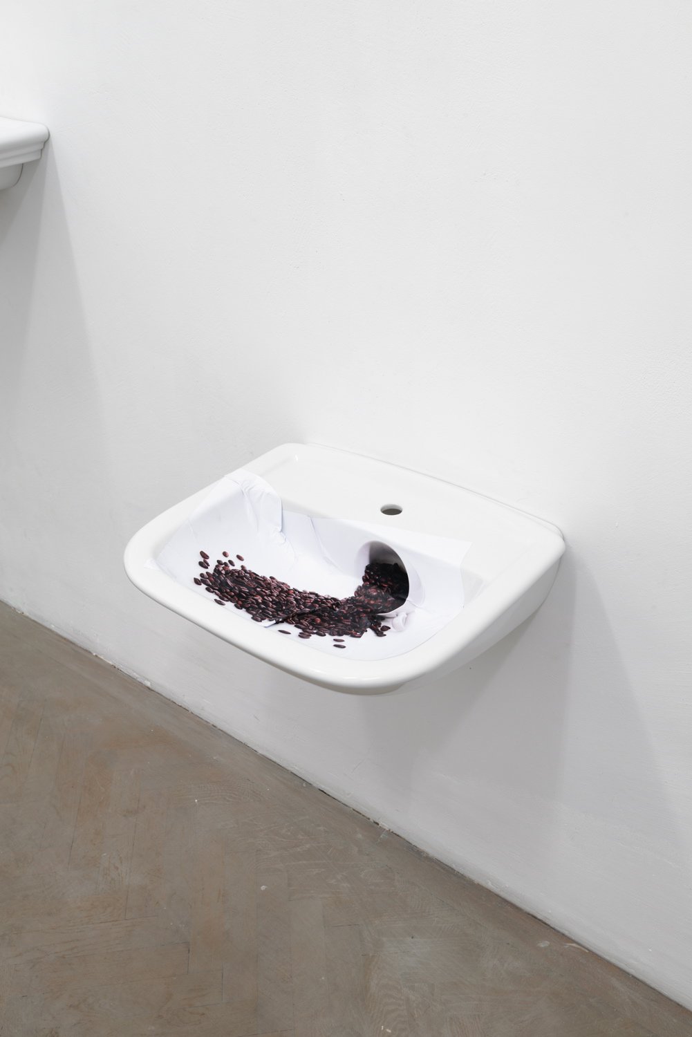 Nina BeierThe Demonstraters (Solid Coffee Spill), 2014Porcelain sink and paper53 x 60 x 22 cm